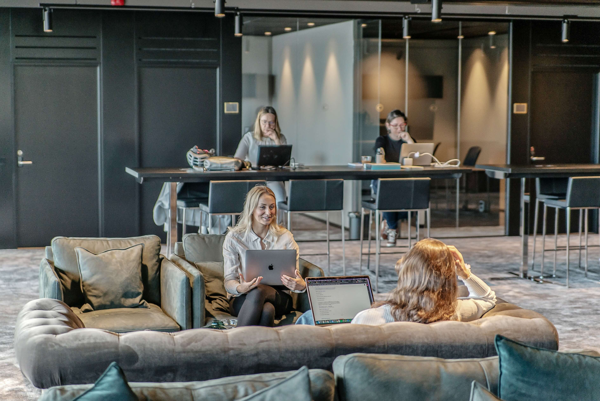Colleagues working together in a modern office lounge
